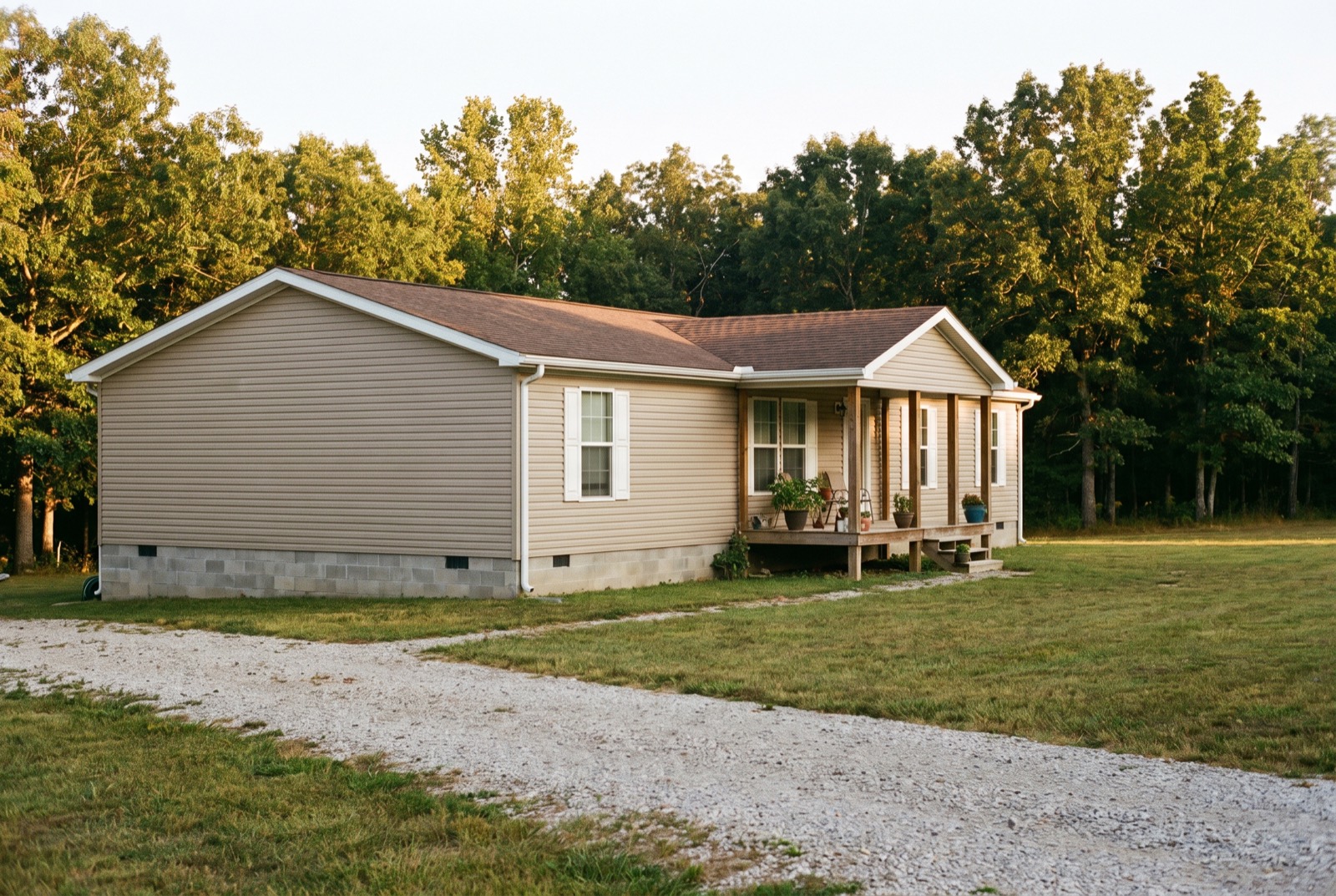 A manufactured home on a wooded hillside lot in the Missouri Ozarks